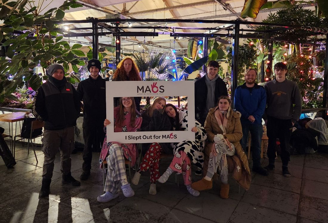 Tutor Irwin Pryce (left) with L3 Uniformed Protective Services students, in pyjamas and warm coats for the MACS charity sleepout